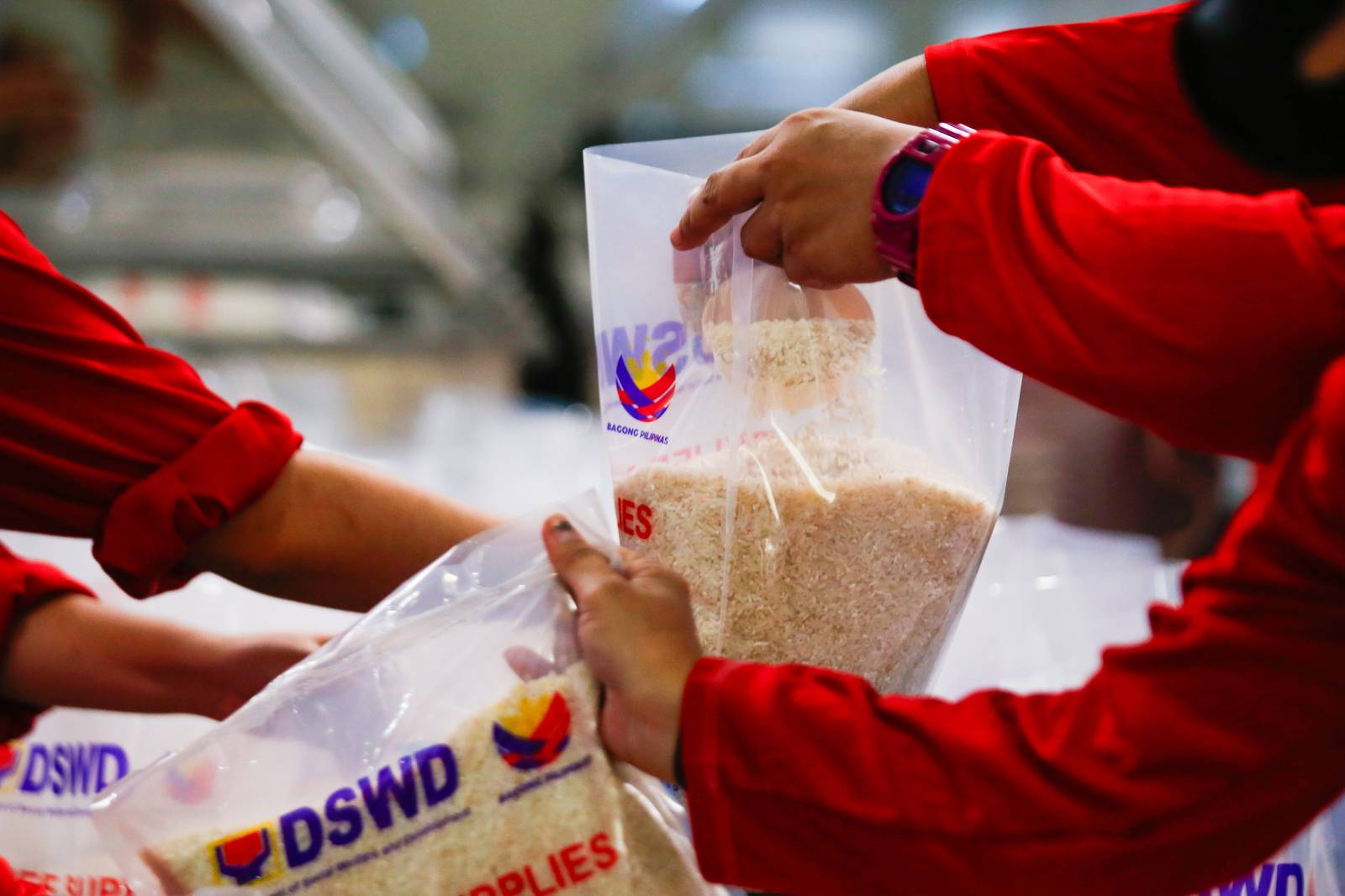 Volunteers and beneficiaries of the Tulong Panghanapbuhay sa Ating Disadvantaged Workers (TUPAD) program assemble Family Food Boxes at the Department of Social Welfare and Development warehouse in Parañaque City on World Humanitarian Day, August 19, 2025. Each food box, good for a family of five, contains 6 kilos of rice, 10 canned goods, 5 sachets of instant coffee, and 5 sachets of chocolate drinks. The initiative aims to support communities in need. World Humanitarian Day honors those who step into crises to help others.