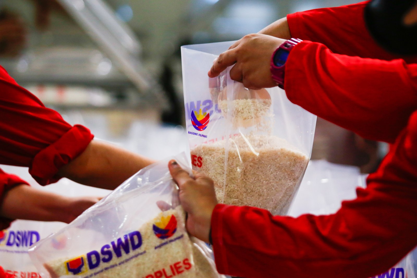 Volunteers and beneficiaries of the Tulong Panghanapbuhay sa Ating Disadvantaged Workers (TUPAD) program assemble Family Food Boxes at the Department of Social Welfare and Development warehouse in Parañaque City on World Humanitarian Day, August 19, 2025. Each food box, good for a family of five, contains 6 kilos of rice, 10 canned goods, 5 sachets of instant coffee, and 5 sachets of chocolate drinks. The initiative aims to support communities in need. World Humanitarian Day honors those who step into crises to help others.