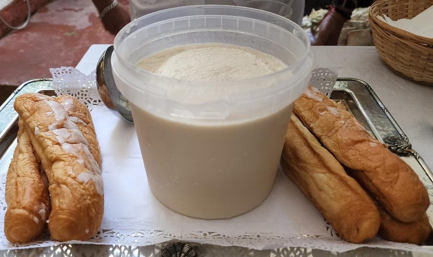 Horchata, a summer drink made from rice, cinnamon and a splash of vanilla and fartons, a Valencian bar shaped sponge cake glazed with sugar.