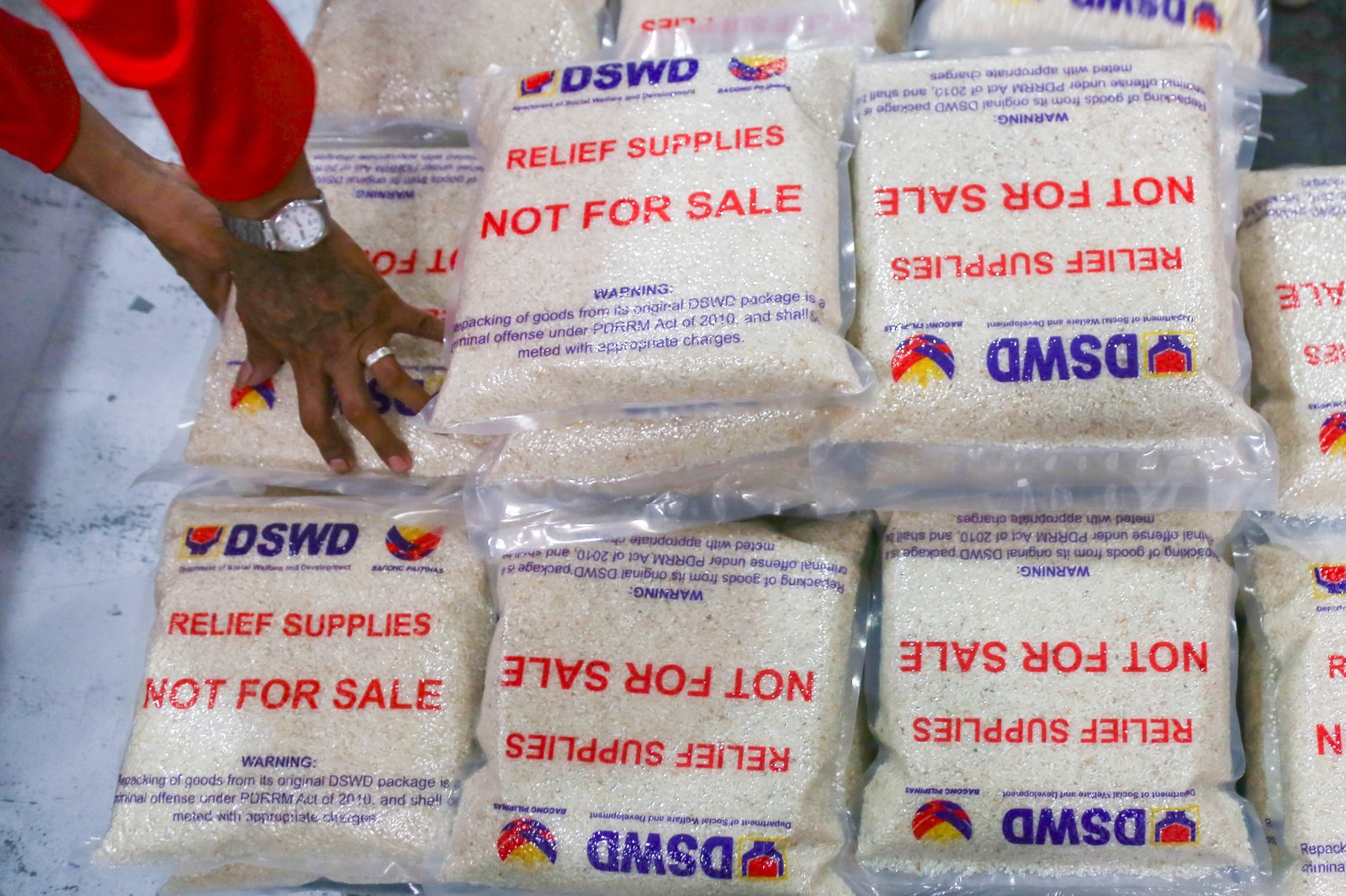 Volunteers and beneficiaries of the Tulong Panghanapbuhay sa Ating Disadvantaged Workers (TUPAD) program assemble Family Food Boxes at the Department of Social Welfare and Development warehouse in Parañaque City on World Humanitarian Day, August 19, 2025. Each food box, good for a family of five, contains 6 kilos of rice, 10 canned goods, 5 sachets of instant coffee, and 5 sachets of chocolate drinks. The initiative aims to support communities in need. World Humanitarian Day honors those who step into crises to help others.