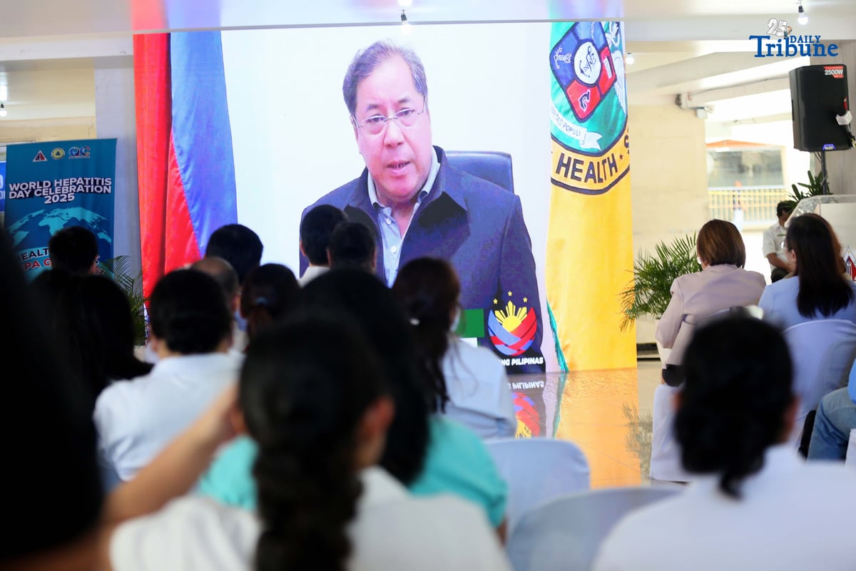 Department of Health Secretary Teodoro J. Herbosa delivers a message on hepatitis via screen to show support for QCitizens during the launch of the Hepatitis B and C Model of Care. The program was led by the Quezon City Health Department (QCHD) and the Office of the City Mayor (OCM), in partnership with Strengthening the Integrated Treatment and Care for Hepatitis (StITCH), as part of the World Hepatitis Day 2025 celebration.