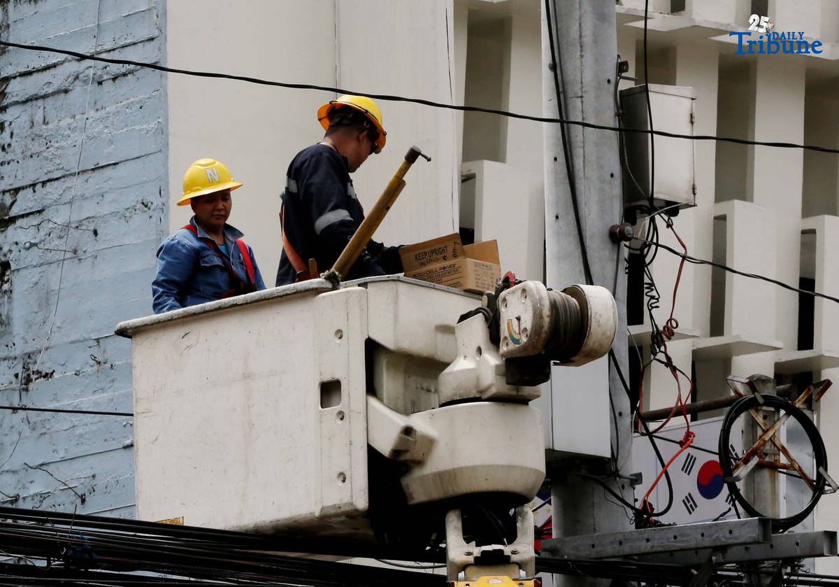 Meralco workers are seen fixing electric lines along East Avenue in Quezon City on Wednesday, August 20, 2025. Last week, the Manila Electric Company (Meralco) announced an upward rate adjustment of P0.6268 per kWh this August due to higher pass-through charges. This brings the overall rate for a typical household to P13.2703 per kWh from P12.6435 per kWh in the previous month.