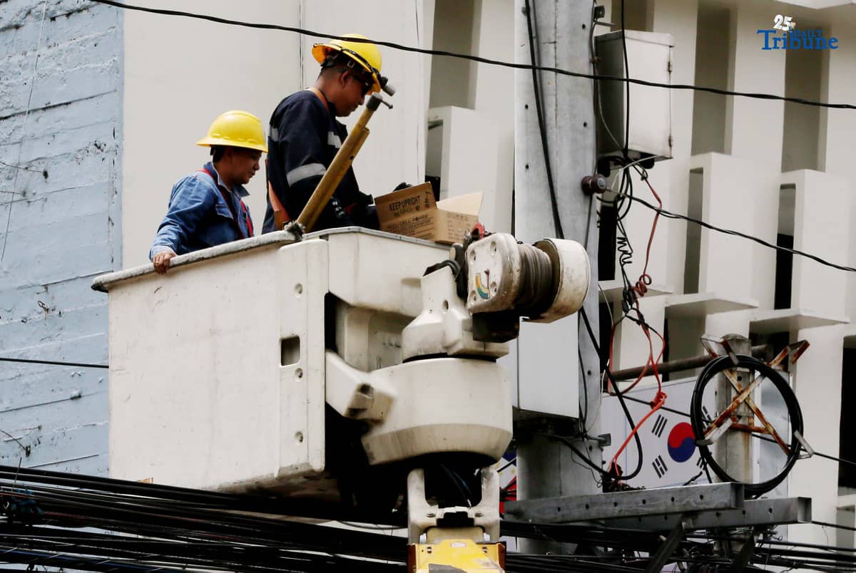 Meralco workers are seen fixing electric lines along East Avenue in Quezon City on Wednesday, August 20, 2025. Last week, the Manila Electric Company (Meralco) announced an upward rate adjustment of P0.6268 per kWh this August due to higher pass-through charges. This brings the overall rate for a typical household to P13.2703 per kWh from P12.6435 per kWh in the previous month.