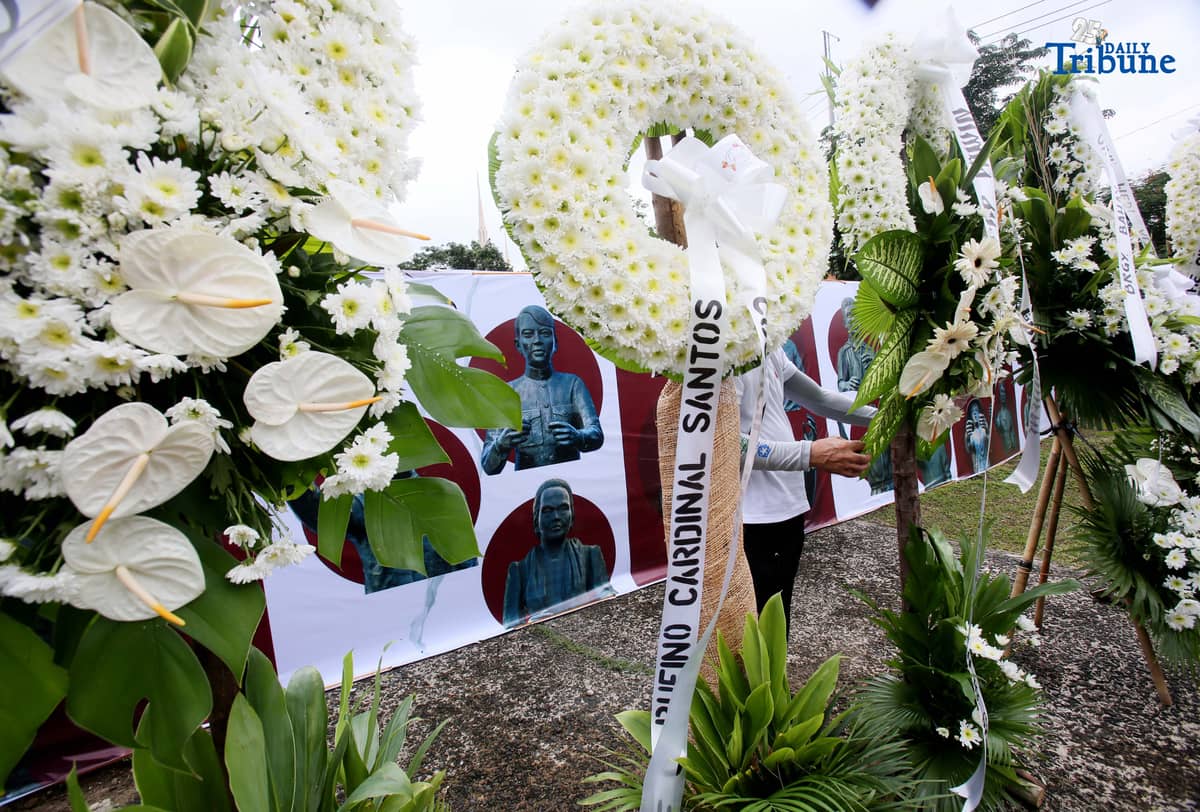 Caretakers arrange flowers offered by Quezon City officials at the Cry of Pugad Lawin Shrine on Saturday, August 23, 2025, during the 129th anniversary of the historic uprising that declared independence from Spanish colonial rule.