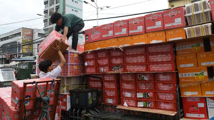 Workers unload boxes of fruits from a delivery vehicle at a commercial area in Manila. The International Trade Union Confederation listed the Philippines among the 10 worst countries for workers in 2025, alongside Bangladesh, Belarus, Ecuador, Egypt, Eswatini, Myanmar, Nigeria, Tunisia and Turkiye due to systemic violations of workers’ rights.