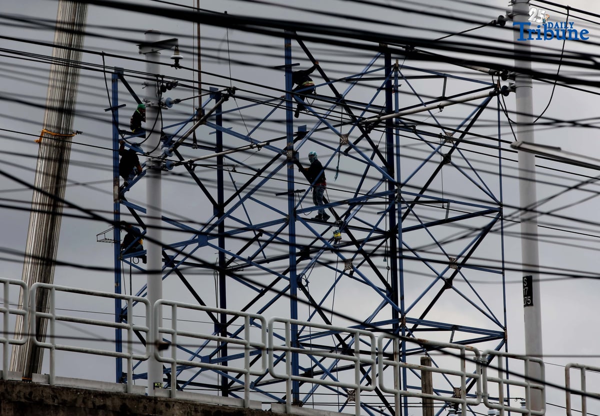 Workers put up a billboard along EDSA in Kamias, Quezon City, on Saturday, August 23, 2025.
