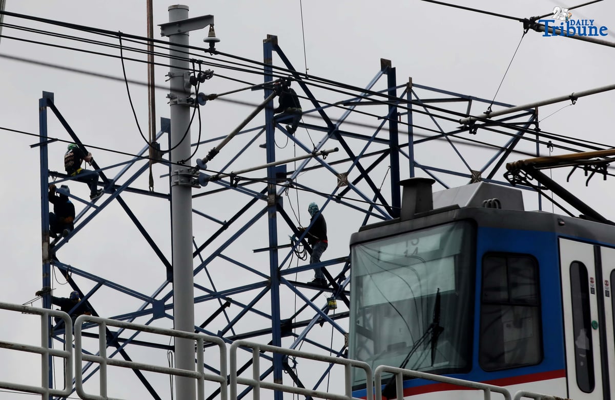 Workers put up a billboard along EDSA in Kamias, Quezon City, on Saturday, August 23, 2025.