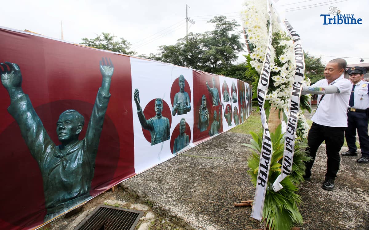 Caretakers arrange flowers offered by Quezon City officials at the Cry of Pugad Lawin Shrine on Saturday, August 23, 2025, during the 129th anniversary of the historic uprising that declared independence from Spanish colonial rule.