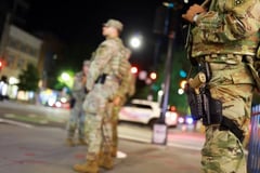 National Guard troops begin carrying weapons in Washington