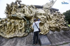 Caretaker tends Tandang Sora mural on National Heroes Day