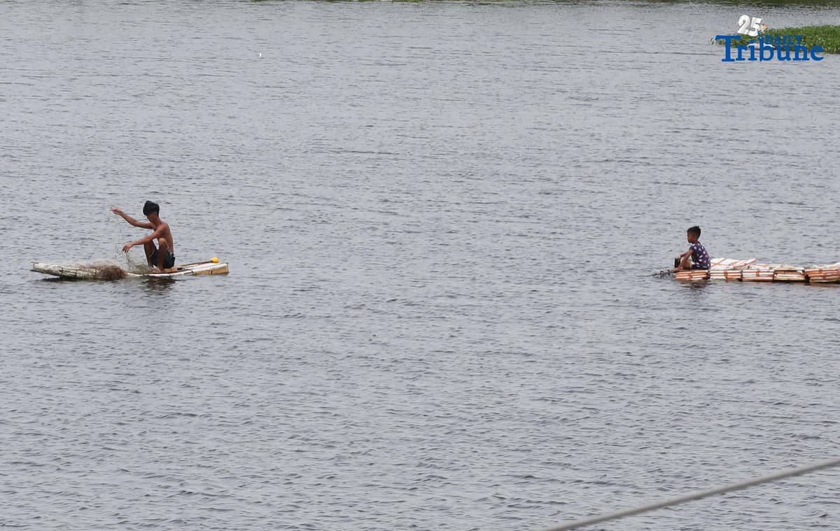 A man riding a makeshift styrofoam boat is seen fishing in Tanza, Navotas City on Thursday, 28 August 2025.