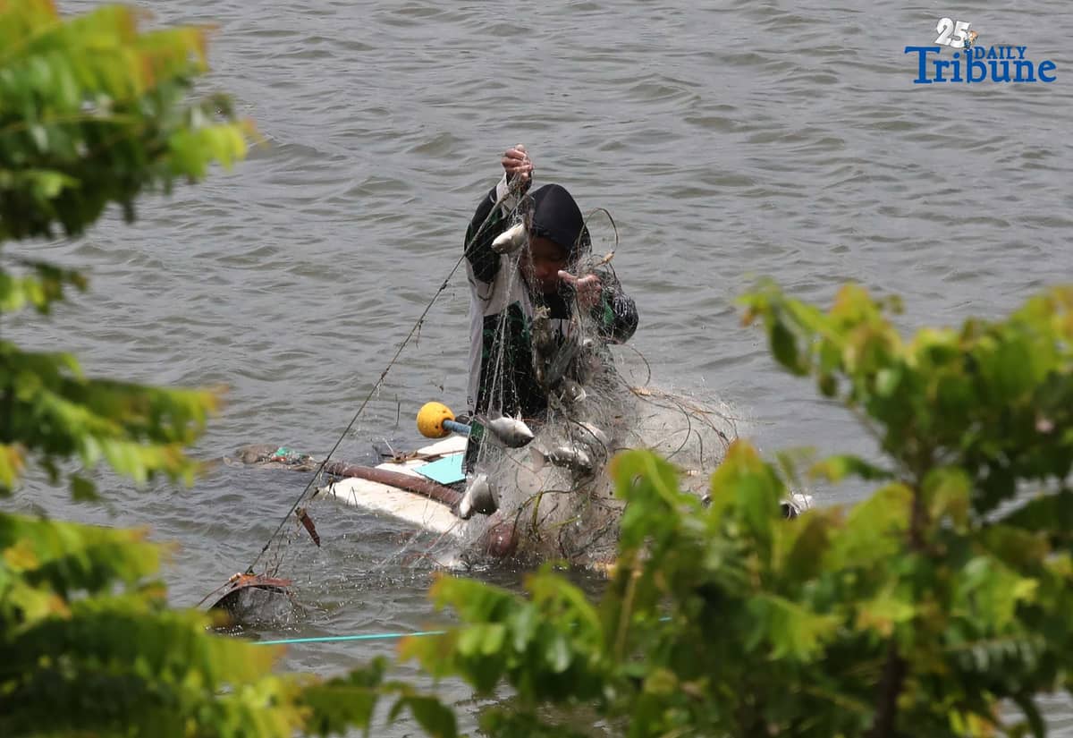 A man riding a makeshift styrofoam boat is seen fishing in Tanza, Navotas City on Thursday, 28 August 2025.