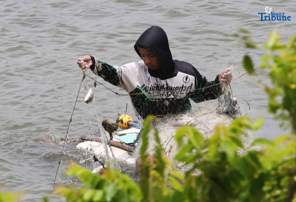 A man riding a makeshift styrofoam boat is seen fishing in Tanza, Navotas City on Thursday, 28 August 2025.