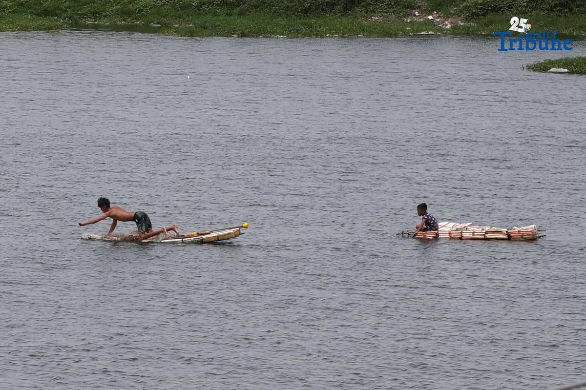 A man riding a makeshift styrofoam boat is seen fishing in Tanza, Navotas City on Thursday, 28 August 2025.