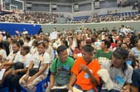 NHA General Manager Joeben A. Tai and Manila Mayor Francisco “Isko Moreno” Domagoso lead the distribution of P11.44 million in cash aid to typhoon-hit families at the San Andres Sports Complex.