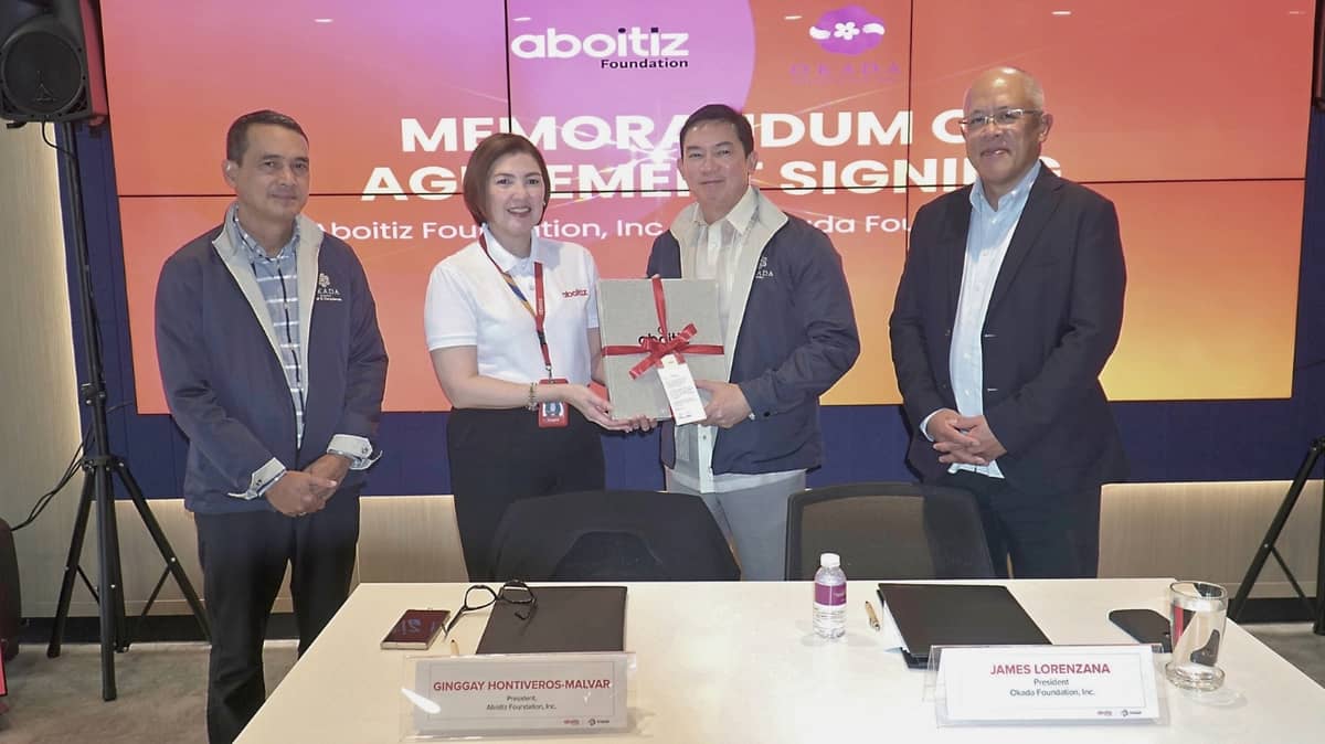ABOITIZ Foundation president Ginggay Hontiveros-Malvar hands an Aboitiz coffeetable book as token to Okada Foundation CEO and president James Lorenzana at the signing of the memorandum of agreement between the two organizations. With them are Okada Manila vice president for government relations and non-gaming compliance Atty. Nelson Victorino (left) and Aboitiz Foundation trustee Jose Emmanuel Hilado (right).