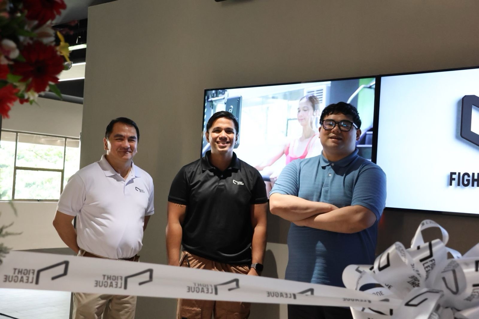 A commitment: Fight League owners Atty. Nilo Divina and his son, Josemaria Raphael A Divina flank coach Chappy Callanta.