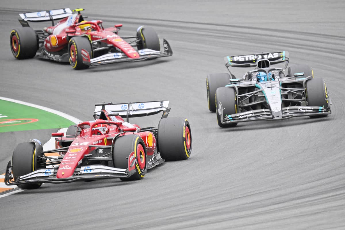 MONEGASQUE driver Charles Leclerc drives in front of Mercedes’ British driver George Russell and Ferrari’s British driver Lewis Hamilton during the Formula One Dutch Grand Prix.