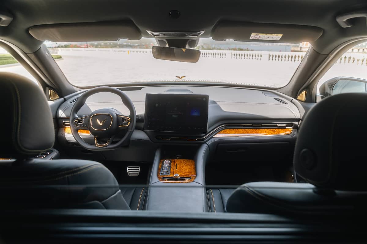 INSIDE the Lac Hong 900 LX, wood accents and premium leather highlight Vietnamese craftsmanship.