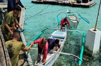 Officers from the Marine Battalion Landing Team rescue the three fishermen who have been stranded near the West Philippine Sea for nearly two days. They were provided assistance and food following their ordeal.