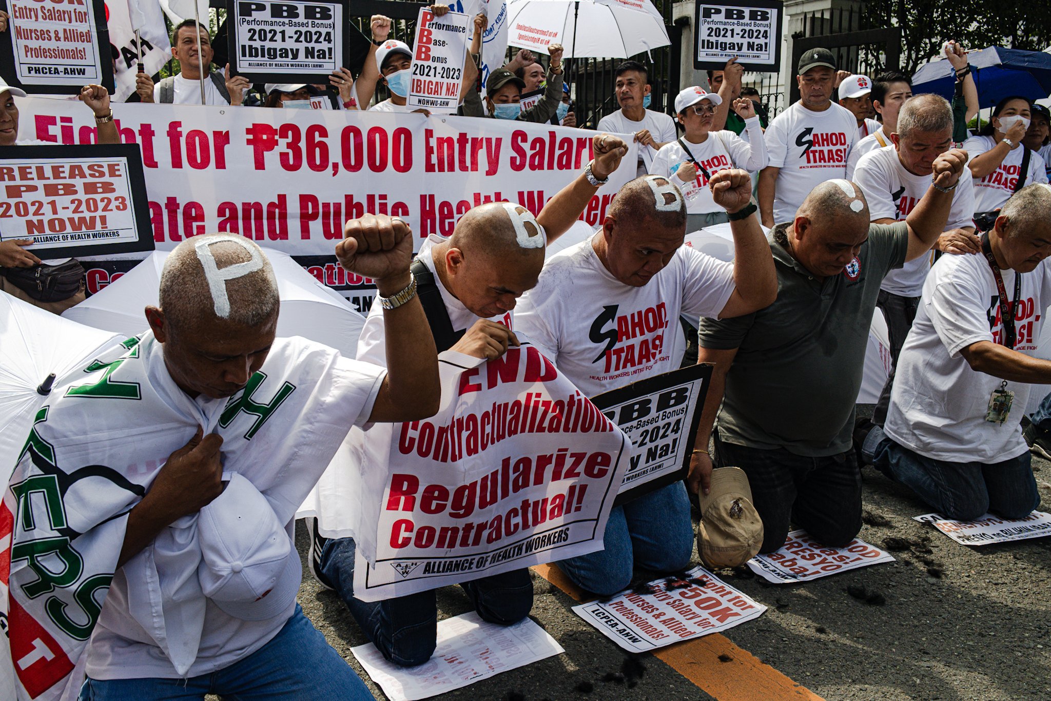 Health workers shave heads in protest over delayed bonuses