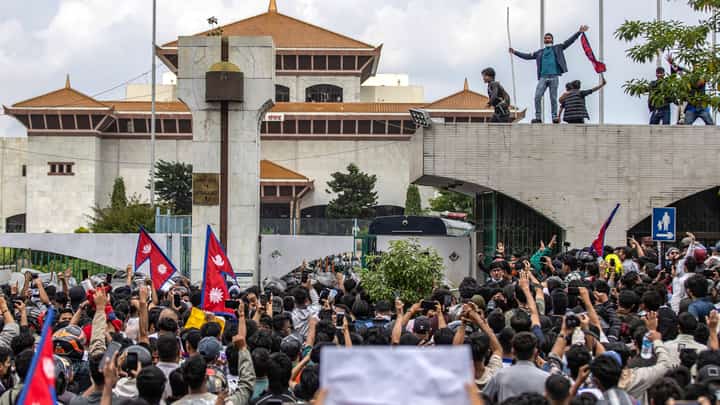 Demonstrators gather outside Nepal’s Parliament during a protest in Kathmandu on 8 September 2025, against social media prohibitions and corruption by the government. Nepal police opened fire, killing at least 17 people as thousands of young protesters took to the streets of Kathmandu demanding the government lift a social media ban and tackle corruption.