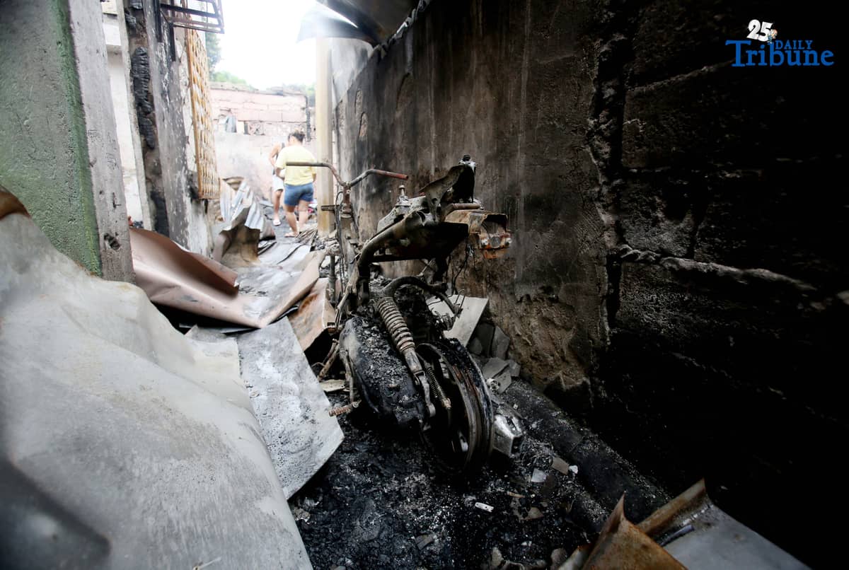 Fire victims sift through what remains of their belongings after a fifth-alarm blaze struck a residential area in Sitio Mabilog, Barangay Culiat, Quezon City, on Tuesday evening, September 9.