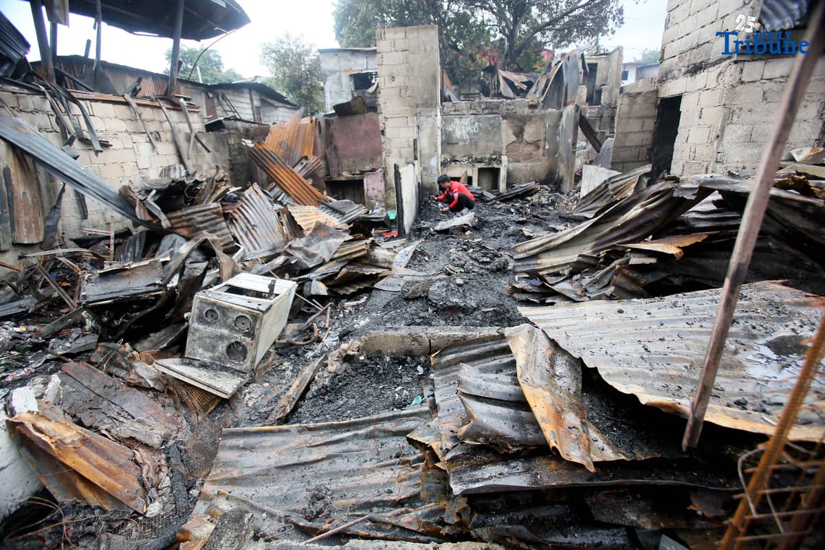 Fire victims sift through what remains of their belongings after a fifth-alarm blaze struck a residential area in Sitio Mabilog, Barangay Culiat, Quezon City, on Tuesday evening, September 9.