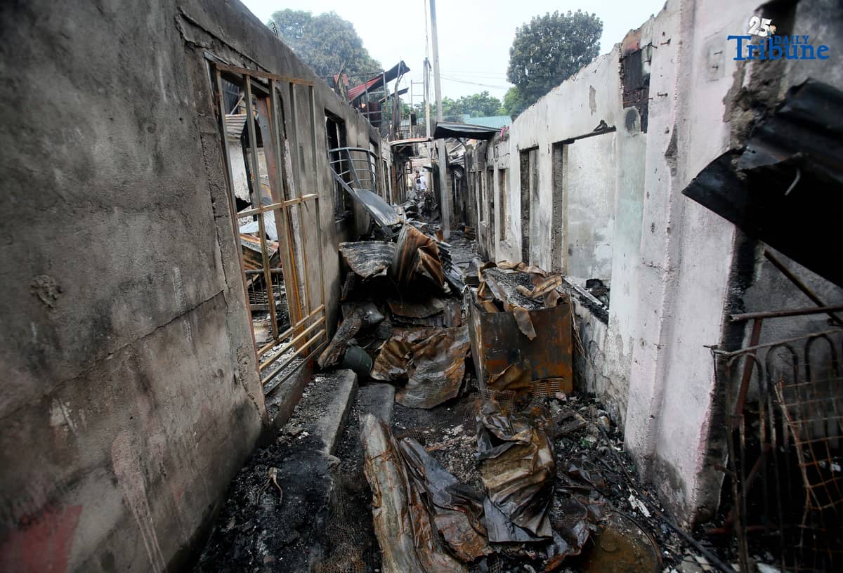 Fire victims sift through what remains of their belongings after a fifth-alarm blaze struck a residential area in Sitio Mabilog, Barangay Culiat, Quezon City, on Tuesday evening, September 9.