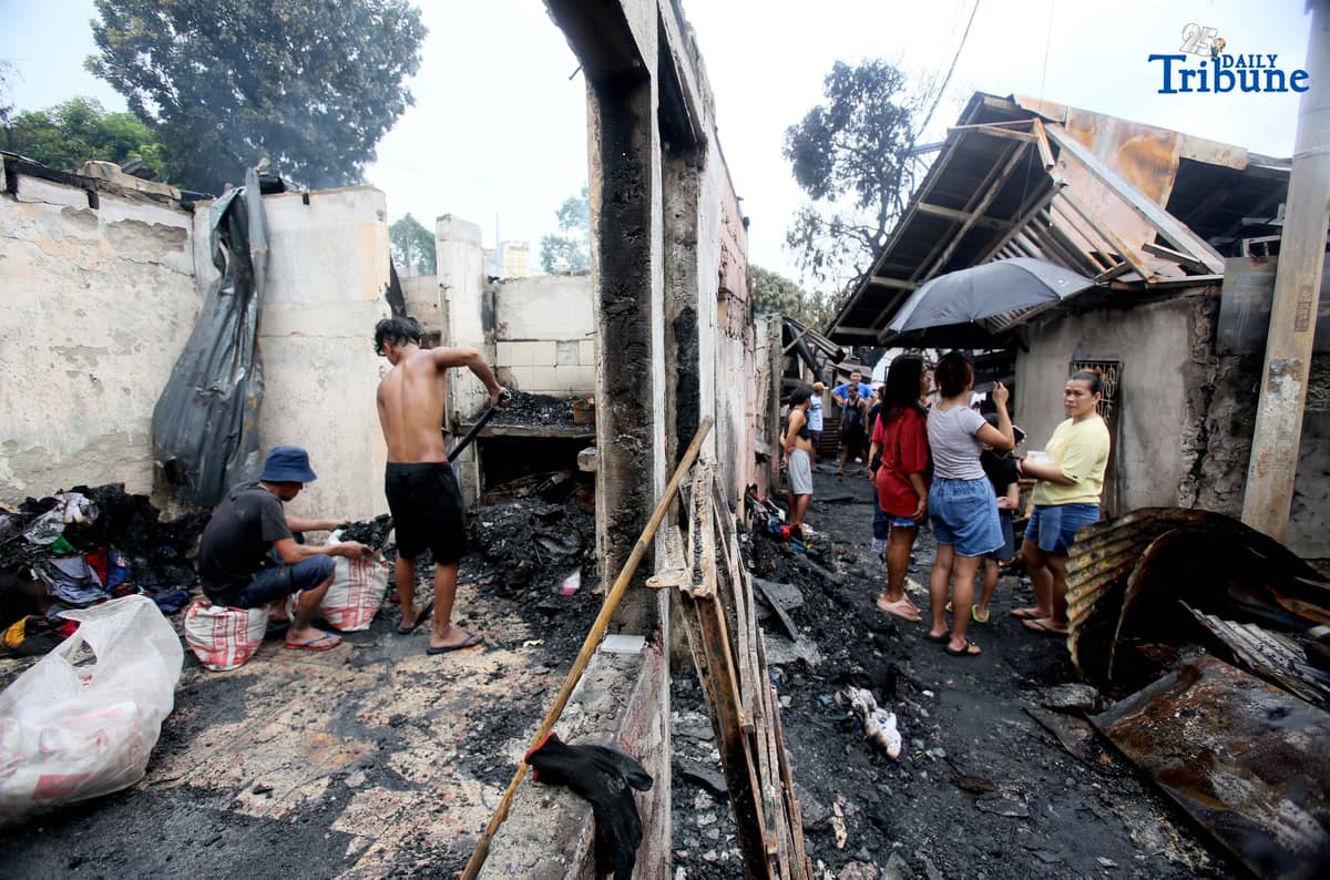 Fire victims sift through what remains of their belongings after a fifth-alarm blaze struck a residential area in Sitio Mabilog, Barangay Culiat, Quezon City, on Tuesday evening, September 9.