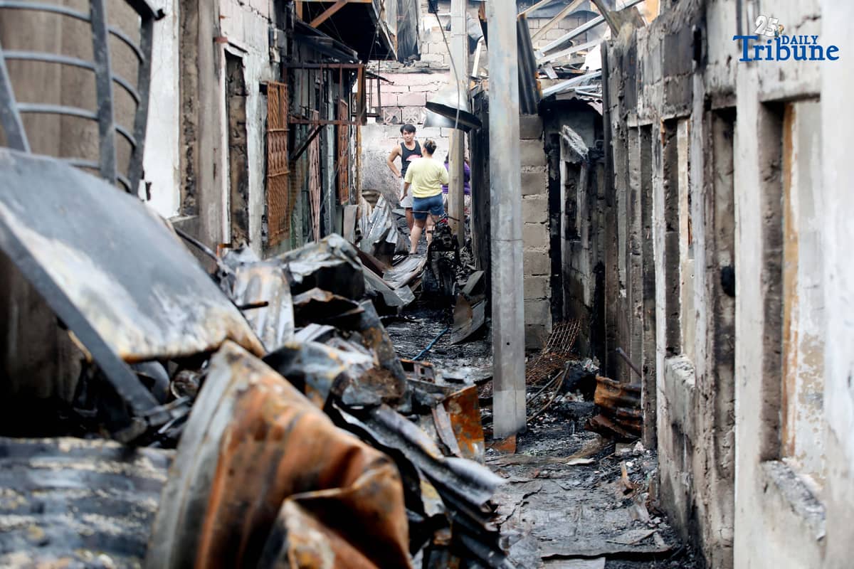 Fire victims sift through what remains of their belongings after a fifth-alarm blaze struck a residential area in Sitio Mabilog, Barangay Culiat, Quezon City, on Tuesday evening, September 9.