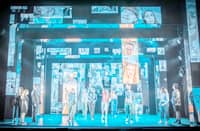 The clever use of mirrored sliding panels and a glasshouse motif — easily assembled for a touring production — amplifies the emotional impact.