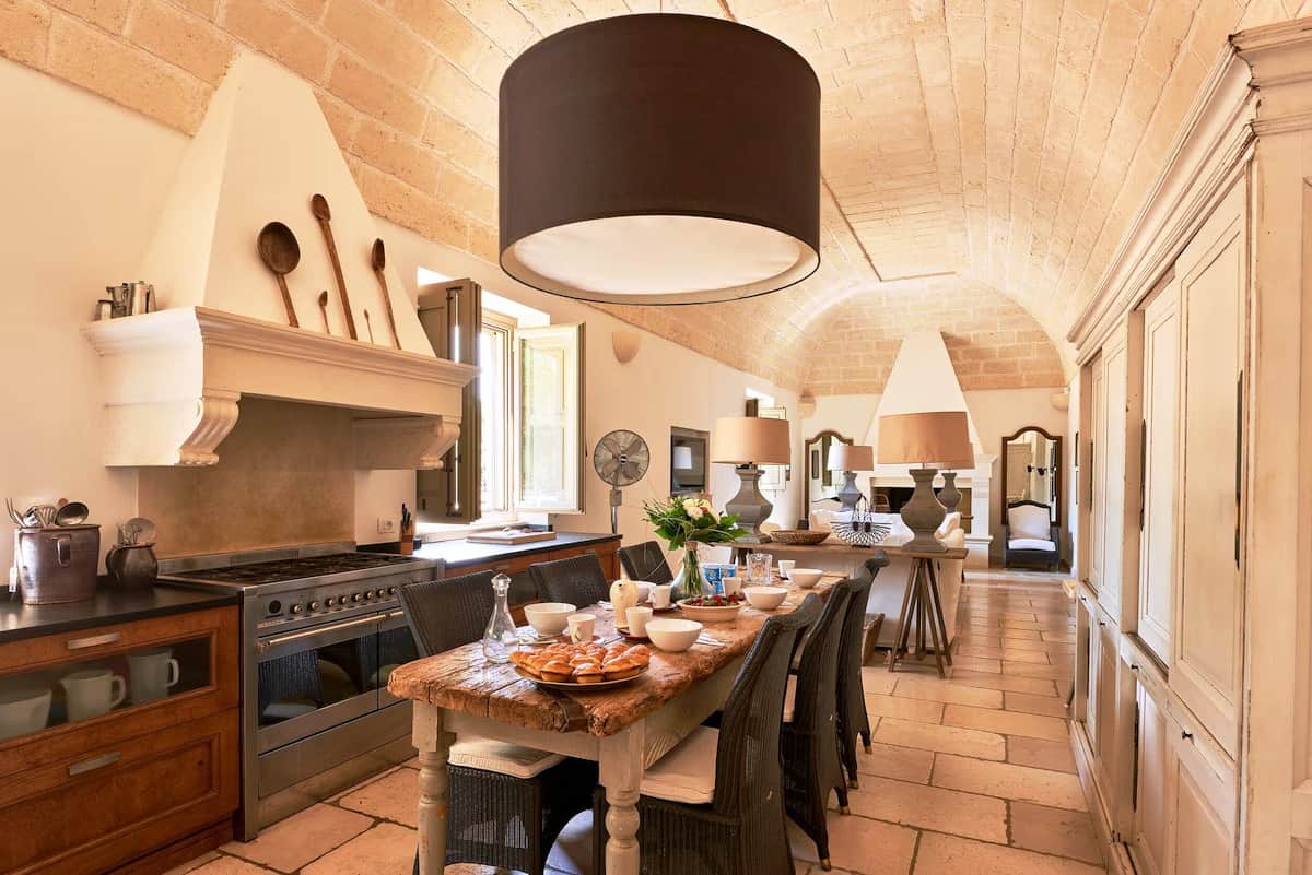 Pale stonewalls and barrel-vaulted ceilings are softly lit by sunlight that seeps through arched windows.
