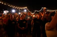 People hold candles during a vigil in memory of right-wing activist Charlie Kirk in Morristown, Arizona, on September 13, 2025. The 31-year-old Kirk was hit by a single bullet while addressing a large crowd at Utah Valley University in the town of Orem on September 10.