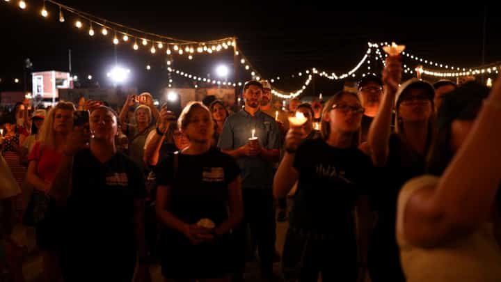 People hold candles during a vigil in memory of right-wing activist Charlie Kirk in Morristown, Arizona, on September 13, 2025. The 31-year-old Kirk was hit by a single bullet while addressing a large crowd at Utah Valley University in the town of Orem on September 10.