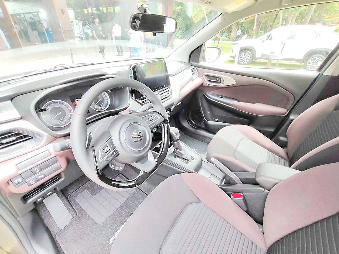 A VIEW of the Fronx cabin featuring its two-tone black and burgundy interior, modern dashboard layout and infotainment system.