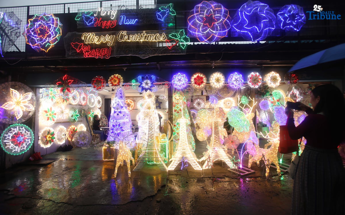 Passersby take photos of a dazzling Christmas lantern for sale at Brgy. North Fairview along Commonwealth Avenue in Quezon City on Sunday night, September 14, 2025. The Philippines celebrates the world’s longest Christmas season, which begins during the “ber” months, with the 100-day countdown to Christmas starting on September 16, 2025.