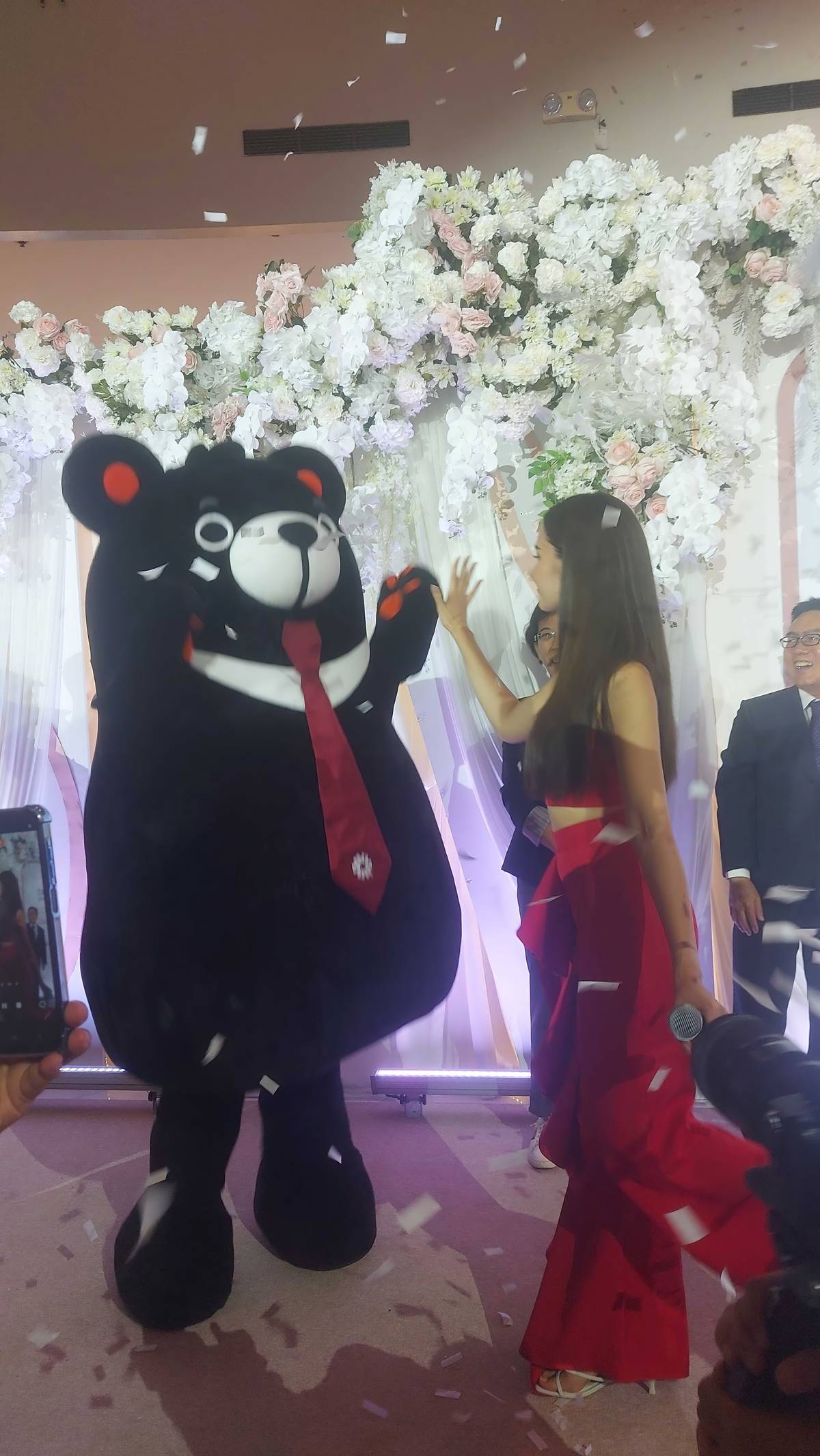 Catriona giving a high-five to the Lohas mascot 'Fu Bear' — a sign of happiness and a key to longevity in Taiwan.
