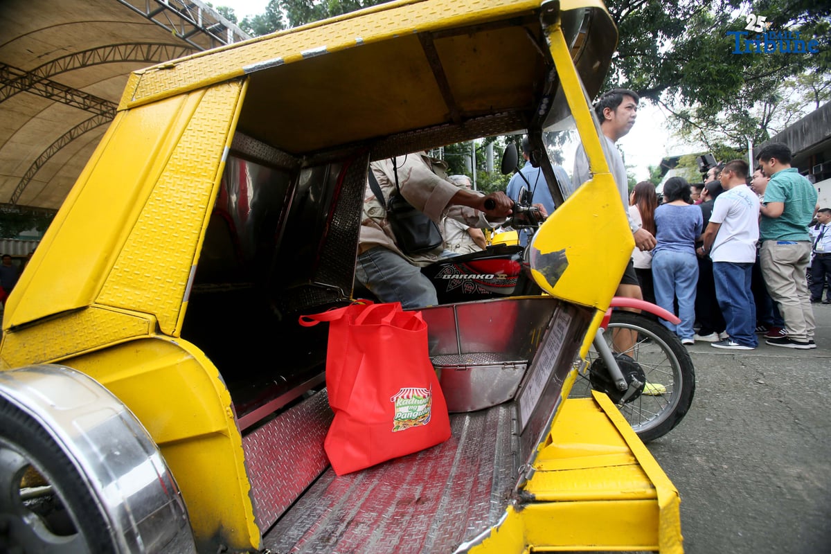 A tricycle driver, a member of a transport group, rides away after buying 10 kilos of rice at P20 per kilo during the rollout of the “Benteng Bigas, Meron Na!” Rice Project for the transport sector. The distribution was held at the Kadiwa ng Pangulo Center in BAI, Quezon City on Tuesday.