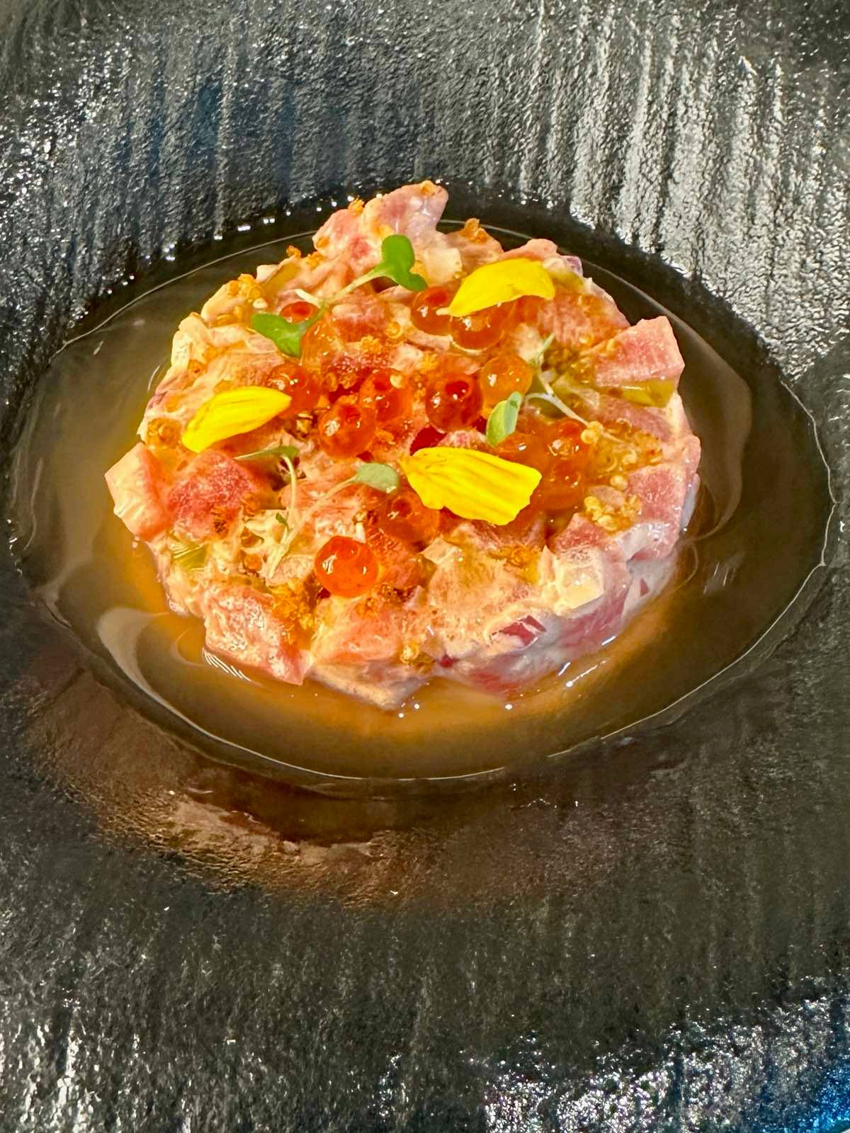 Ikura-topped GenSan tuna, kimchi aiolo, quinoa furikake, fermented blood orange dressing, house-made rice crisps.