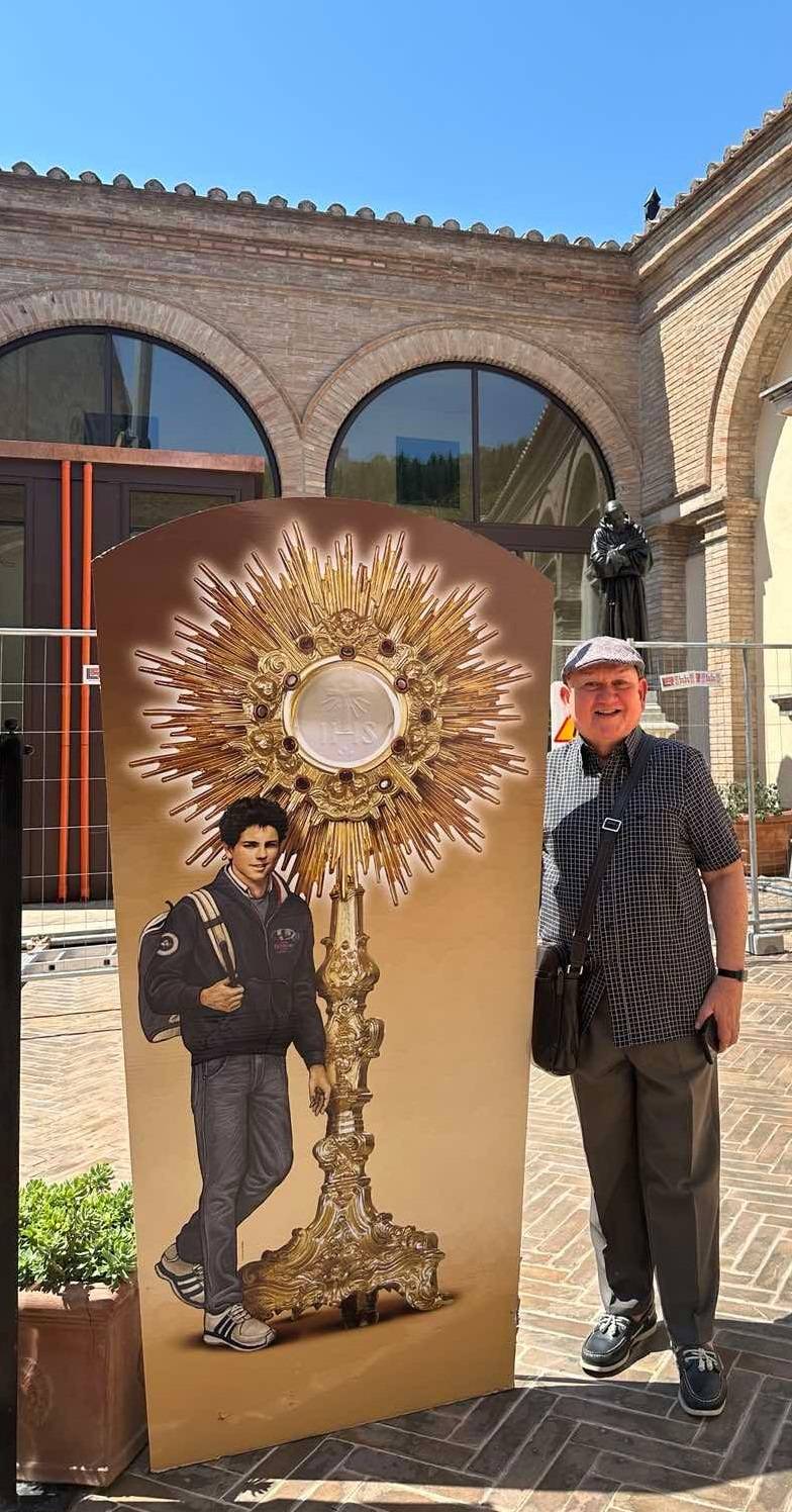 Treasured memorabilia The author with a standee of the saint.