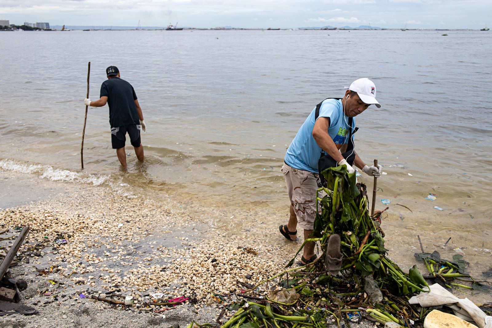 Around 4,000 volunteers pick up trash floating in and around the dolomite beach in Manila Bay on Saturday, 20 September 2025, in observance of International Coastal Clean-Up Day.