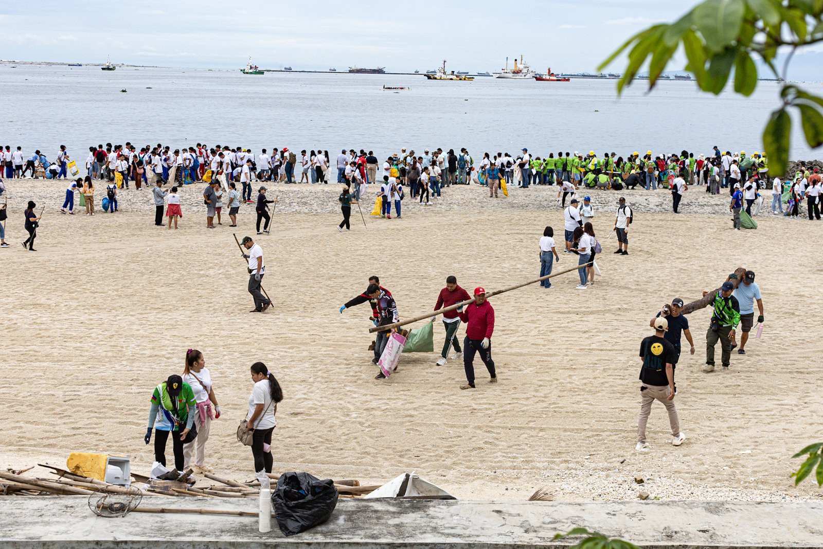 Around 4,000 volunteers pick up trash floating in and around the dolomite beach in Manila Bay on Saturday, 20 September 2025, in observance of International Coastal Clean-Up Day.