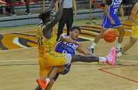 JARED Bahay of Ateneo braves the defense of Mo Konateh of FEU to make a drop pass to teammate Kymani Ladi during the crucial stretch of their UAAP Season 88 men’s basketball tournament game yesterday at the UST Quadricentennial Pavilion. The Blue Eagles prevailed in overtime, 86-83.