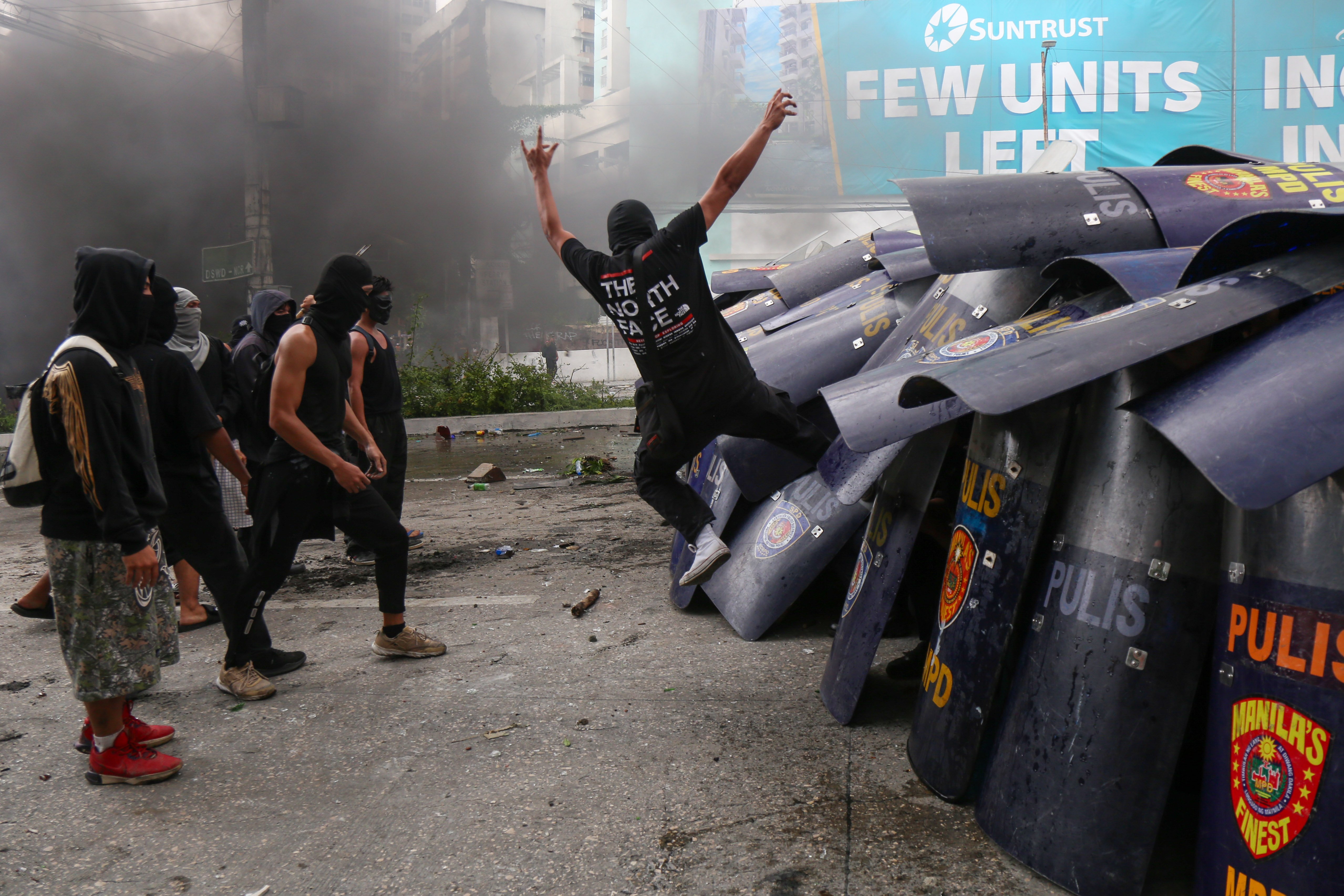 Phalanx Masked and hooded men attack a squad of police officers huddled behind their shields in Manila, igniting a night of chaos on 21 September, 53 years to the day of Ferdinand Marcos Sr.’s proclamation of Martial Law.