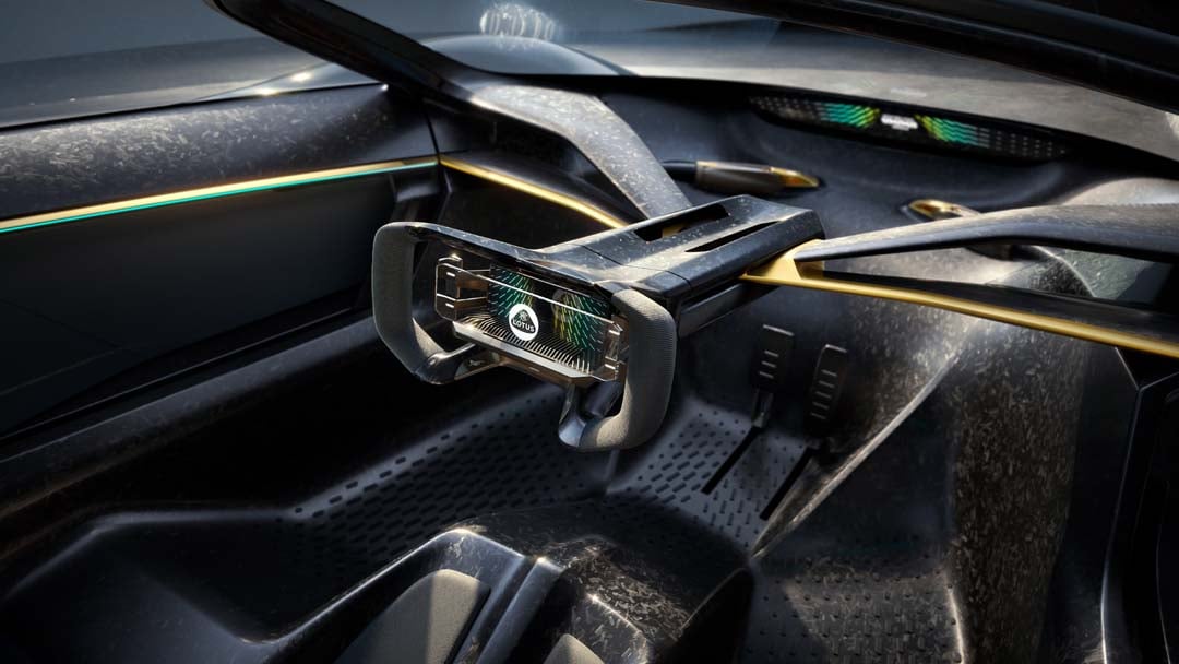 Inside the Lotus Theory 1, the futuristic steering setup emphasizes the central driving position.