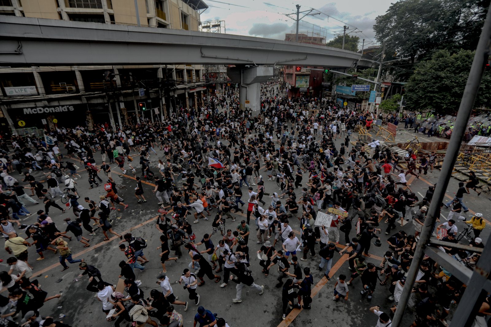 IN PHOTOS: Various progressive groups from different sectors marched down from the pilot rally area in Luneta to Mendiola Peace Arch to protest the irregularities and anomalies in governance on Sunday, 21 September, 2025.  Tensions that turned into a violent dispersal follows as a truck container and police barricade restricted protesters from crossing Ayala Bridge that caused the truck and a motorcycle to be set on fire. 

In Mendiola, a series of stampedes, tear gas explosions, and riot with the police were also seen till night as protesters threw solid objects to resist with the police barricade. Disrupting sounds were also heard playing through the city's speakers. 

Some attendees involved in the protest were arrested by authorities.|Aram Lascano