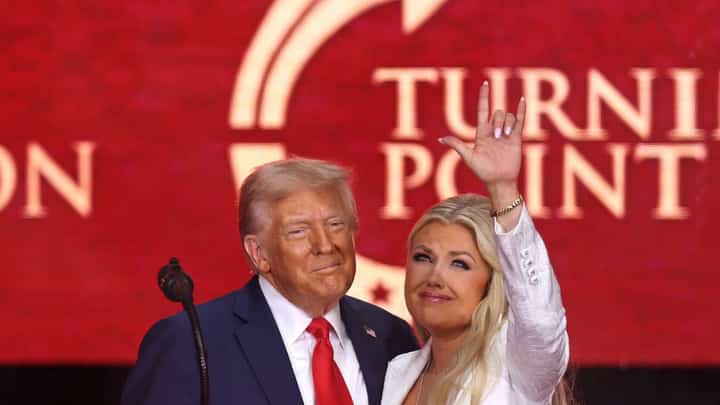 US President Donald Trump and Erika Kirk, Charlie Kirk's widow, gesture during the public memorial service for right-wing activist Charlie Kirk at State Farm Stadium in Glendale, Arizona, on September 21, 2025.