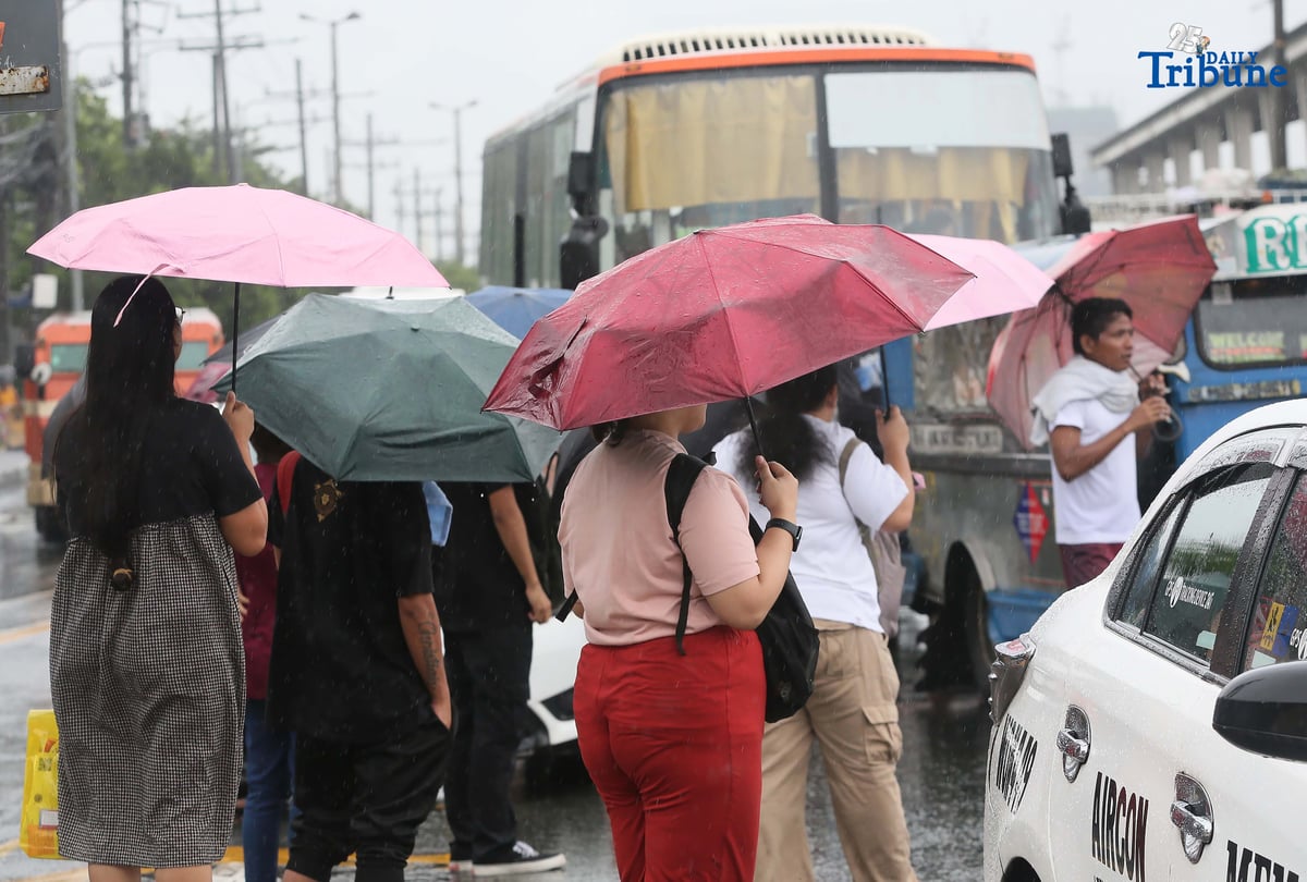 (September 23 2025) Commuters used umbrella to protect them selves from the rain brought by super typhoon Nando, while waiting a public transport along Commonwealth in Quezon City on Tuesday September 23 2025. Photo/Analy Labor