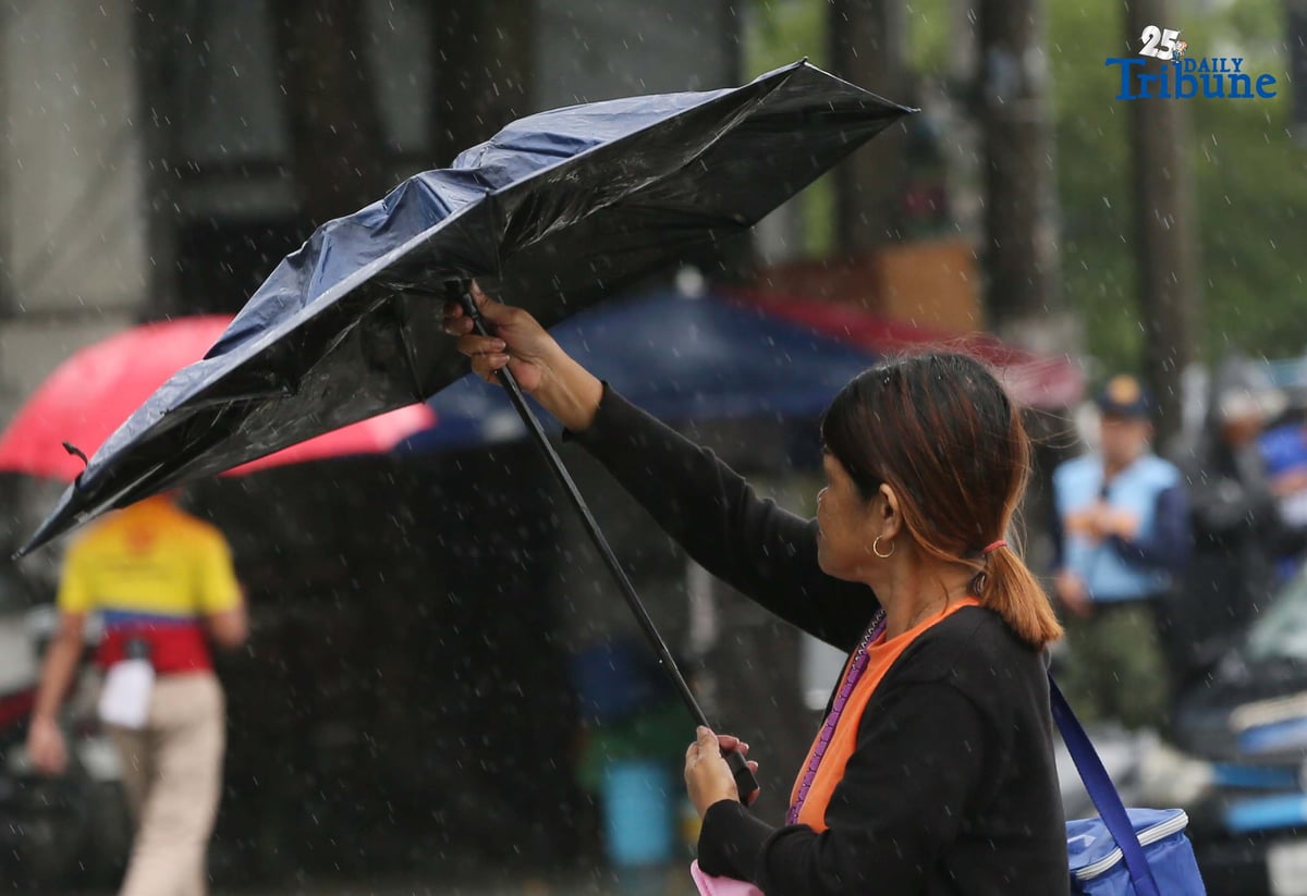 (September 23 2025) Commuters used umbrella to protect them selves from the rain brought by super typhoon Nando, while waiting a public transport along Commonwealth in Quezon City on Tuesday September 23 2025. Photo/Analy Labor
